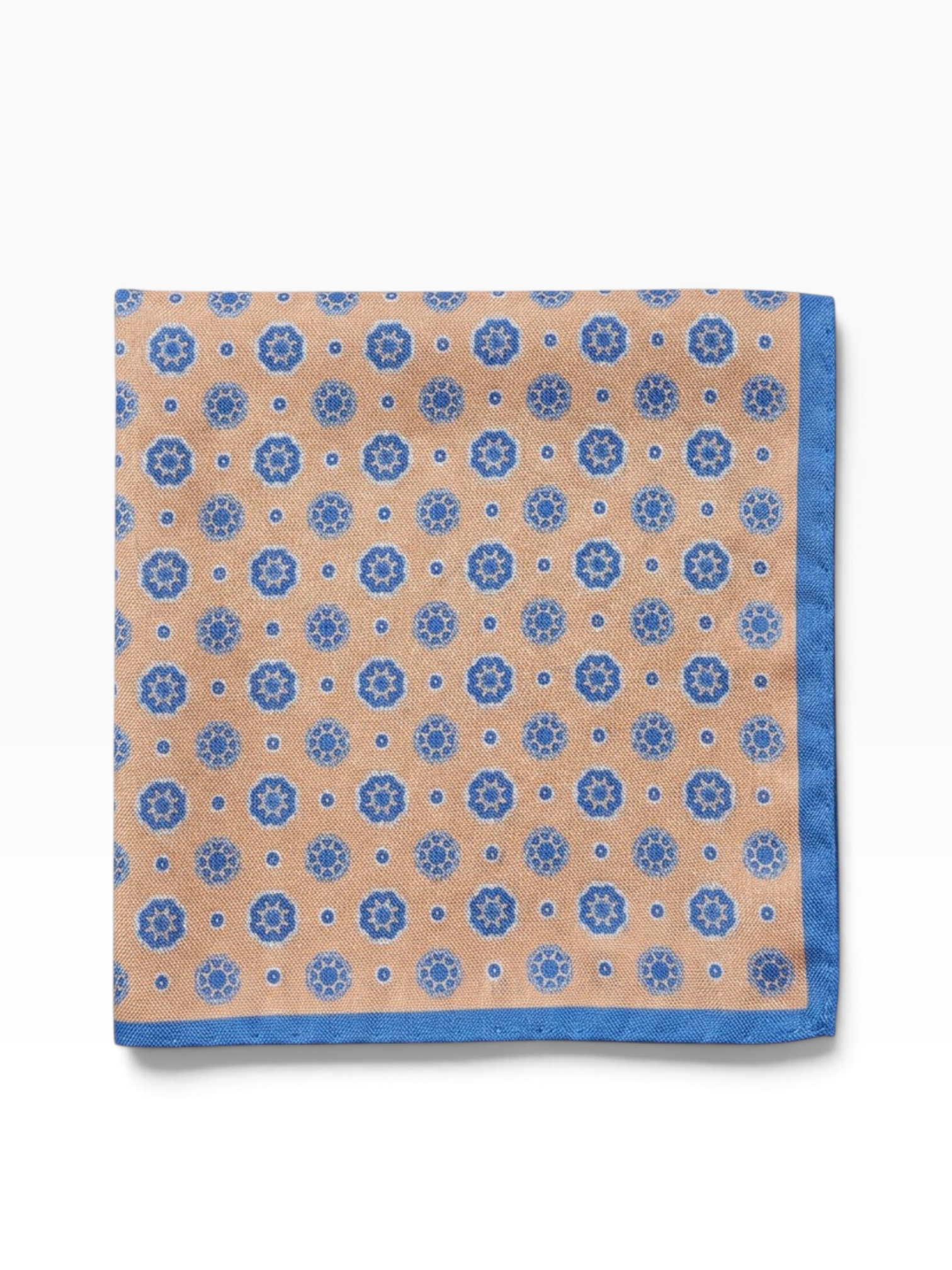 Bourgee a world class shoe store peach silk pocket square with blue geometric print and a contrasting blue border.