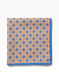 Bourgee a world class shoe store peach silk pocket square with blue geometric print and a contrasting blue border.