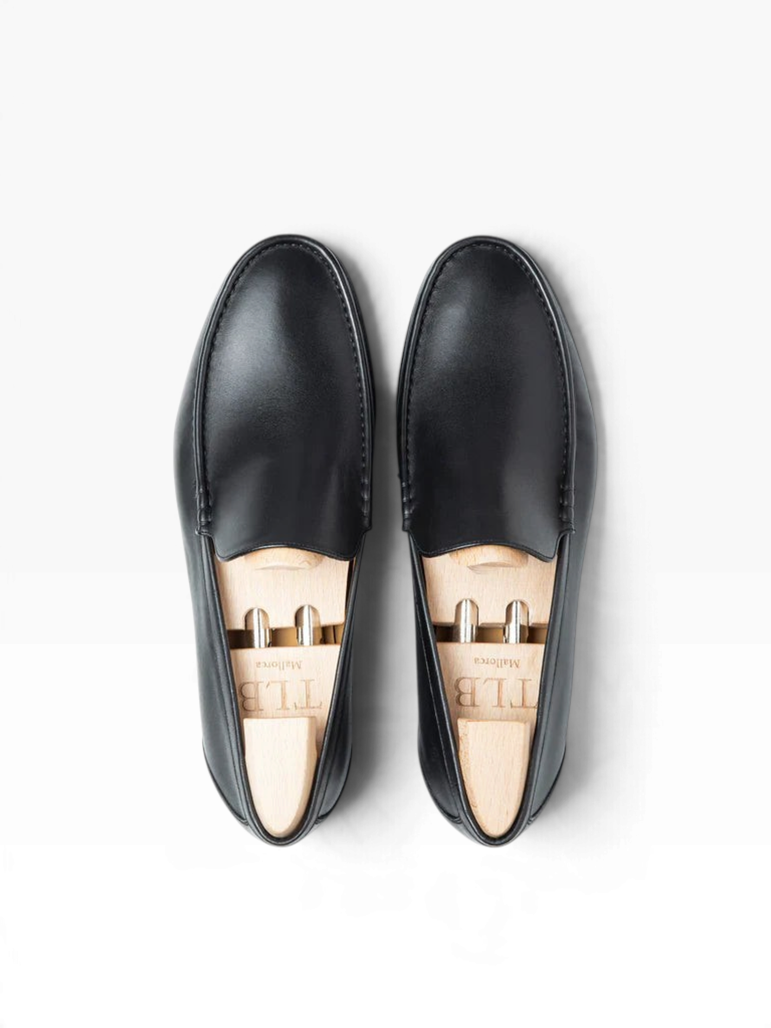 Bourgee a world class shoe store TLB Kiowa black Funchal leather penny loafers with wooden shoe trees, top view.