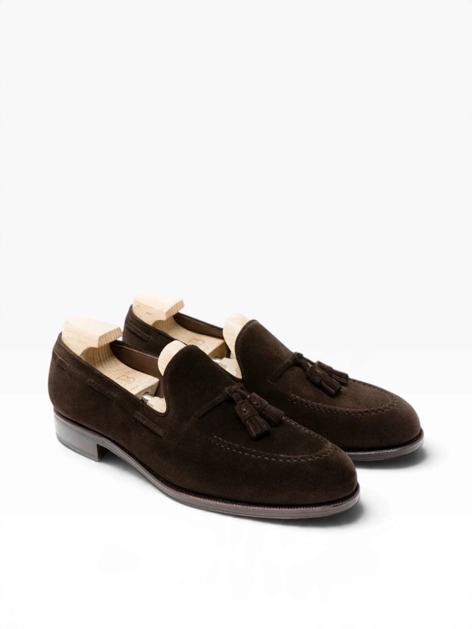 Bourgee a world class shoe store brown suede tassel loafers with a round toe and leather sole on a white background