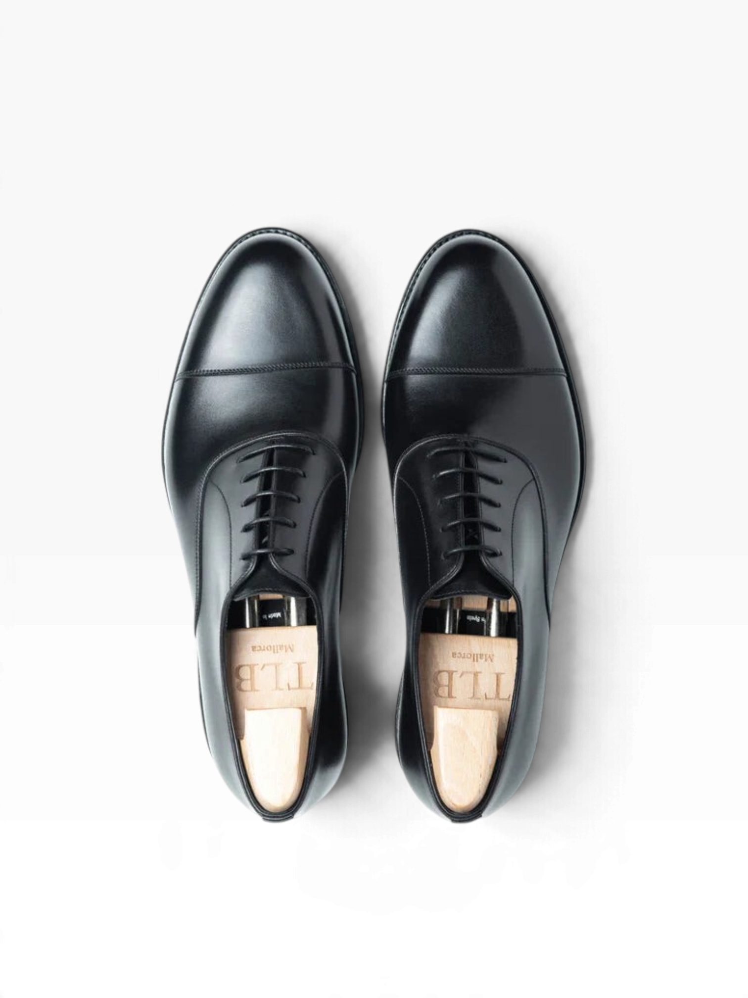 Bourgee a world class shoe store TLB Adam black boxcalf cap toe oxford shoes with wooden shoe trees, top view.
