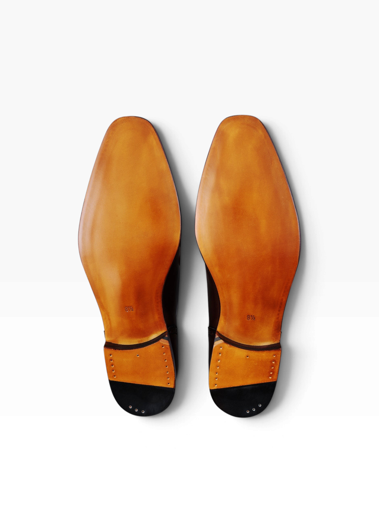 Bourgee a world class shoe store TLB Lancaster tassel loafers showing the smooth tan leather soles and stacked heels.