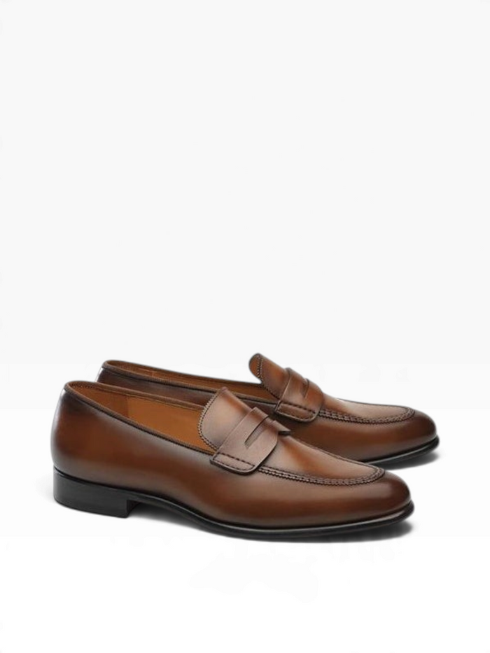 Bourgee a world class shoe store Carlos Santos Oliver penny loafers in brown leather with a distinctive red sole.