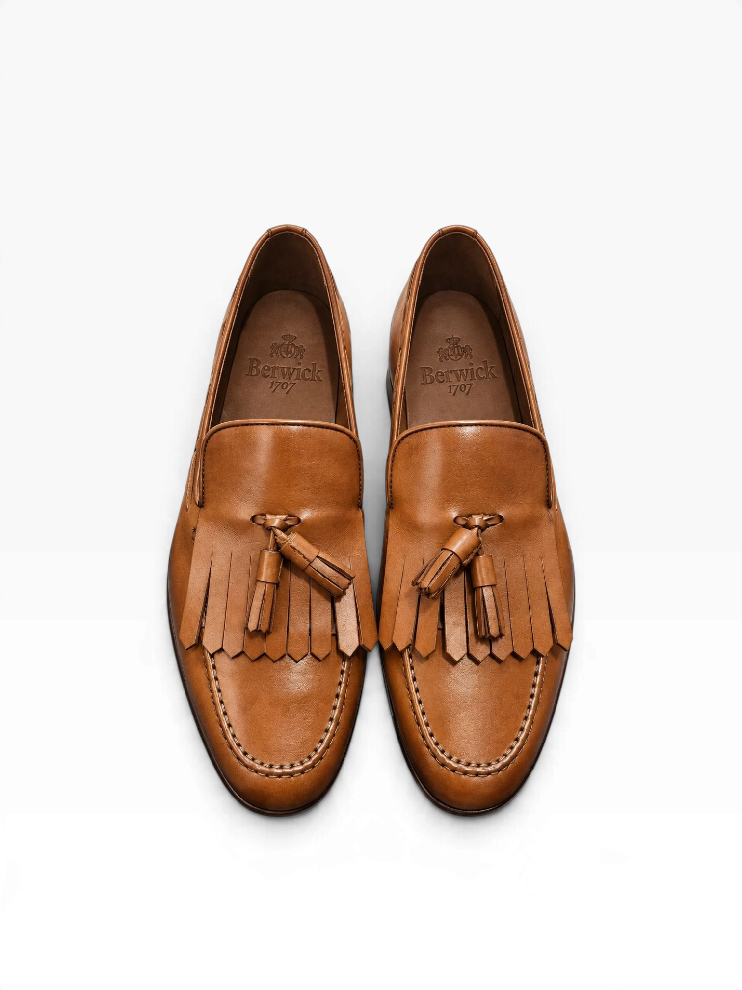 Bourgee a world class shoe store Berwick 1707 tan leather tassel loafers with kiltie fringe and apron toe stitching.